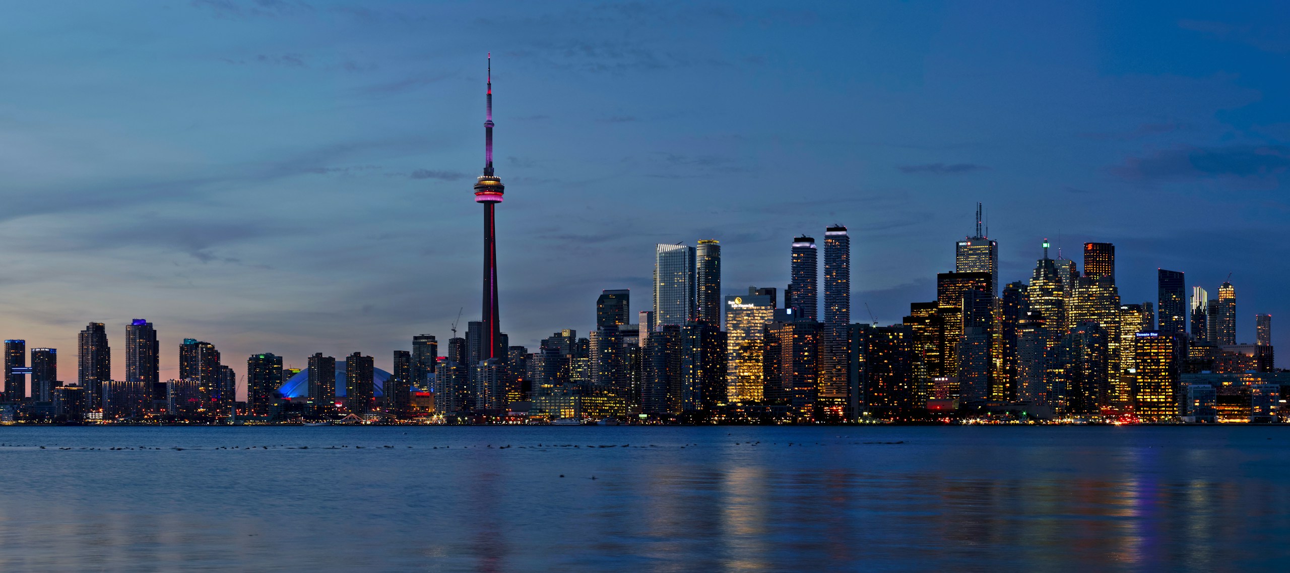 Toronto and GTA skyline over Lake Ontario at dusk with blue sky, Ontario-wide delivery and pickup